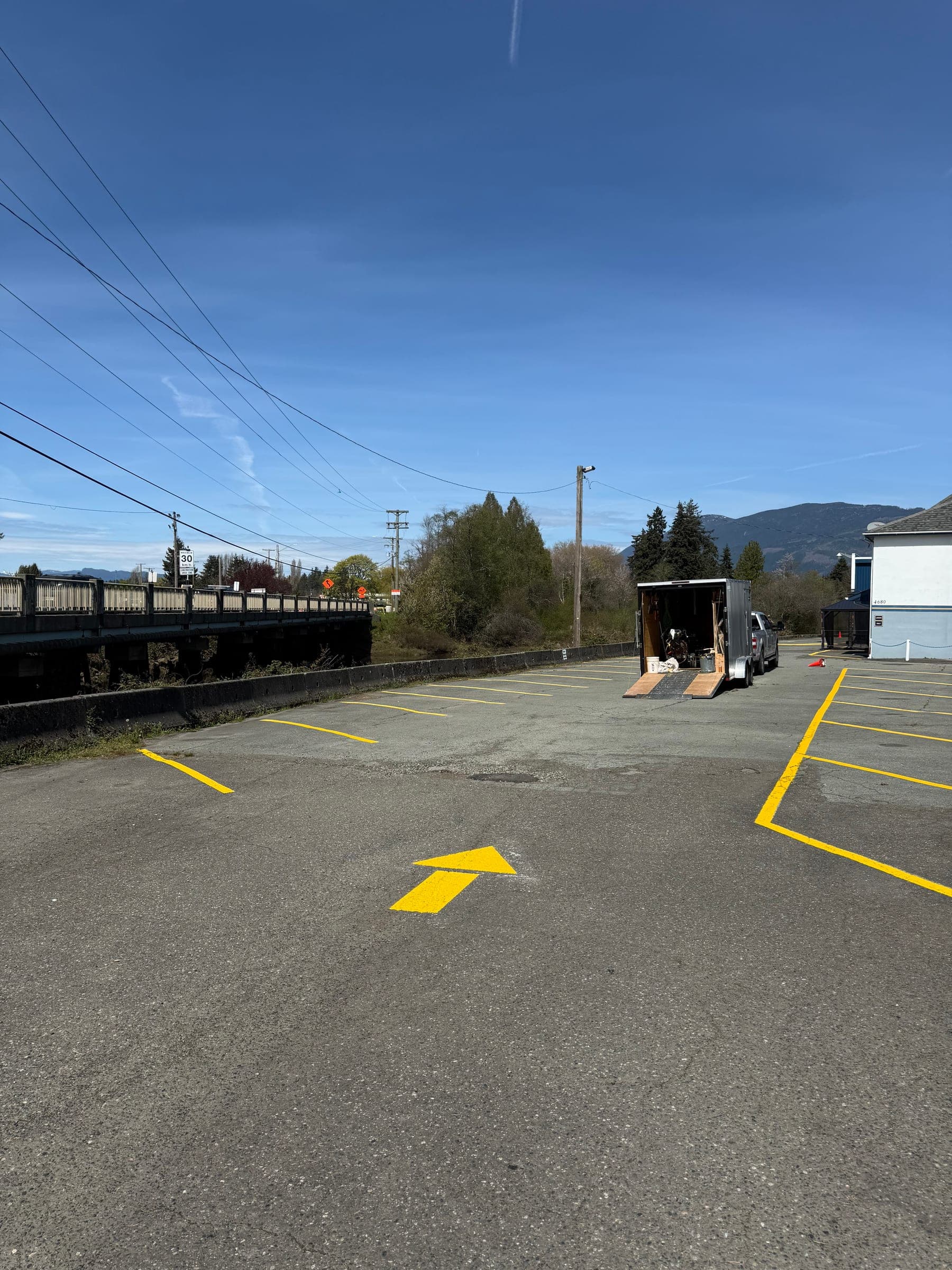 After photo of fresh yellow directional arrows and parking lines.