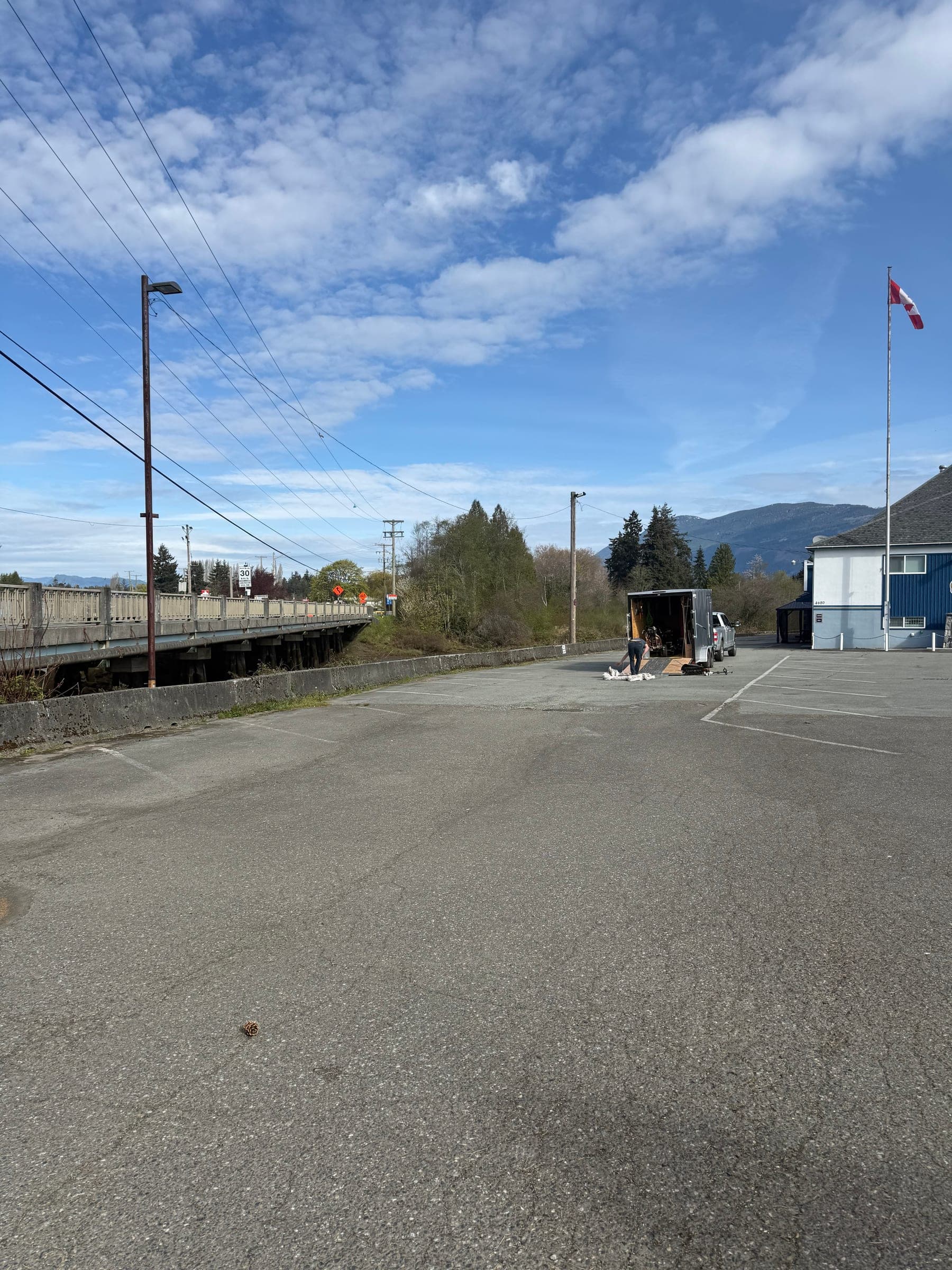 Before photo of an unpainted parking lot beside a blue building.