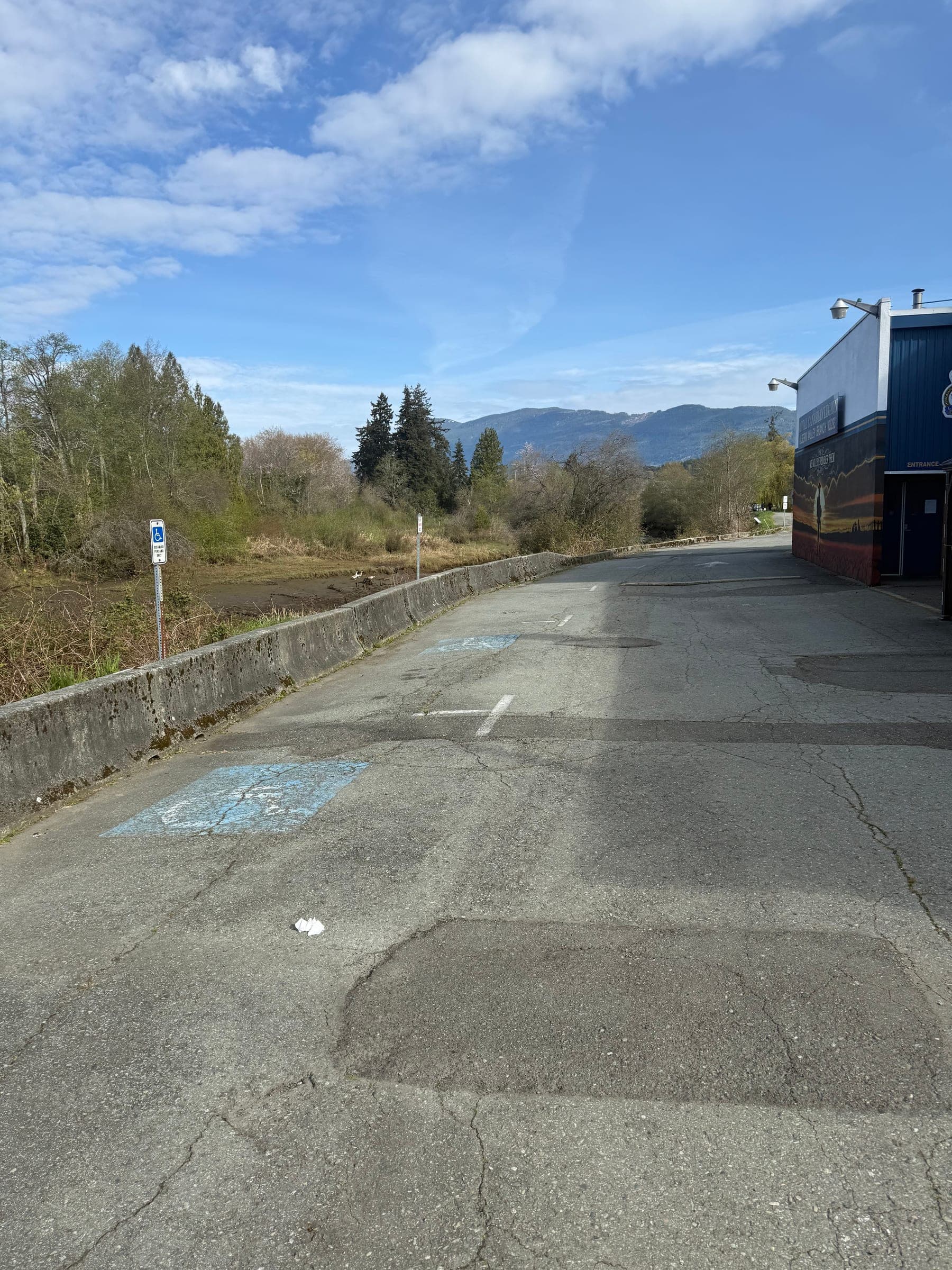 Before photo of faded accessible parking markings and worn asphalt.